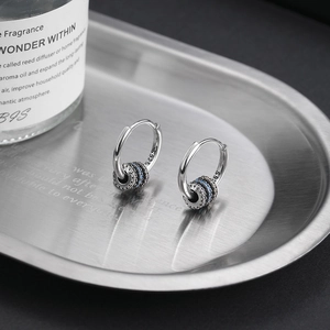 S925 sterling silver hoop earrings with blue gear charm on a sleek metal tray