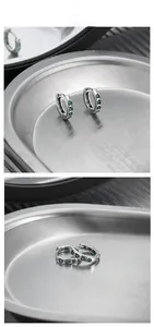 Detailed view of S925 silver hoop earrings with heart-shaped green cubic zirconia stones