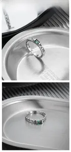 Detail of square emerald silver ring featuring vintage crater texture and open band