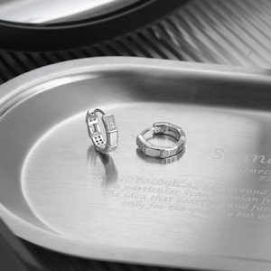 S925 Sterling silver hoop earrings with white zircon inlays on a metallic tray
