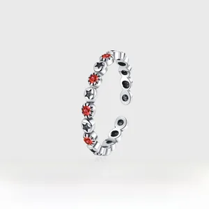Detail of vintage silver star ring with red zircon inlay and adjustable open band