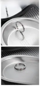 Detail of vintage S925 silver star ring with red zircon inlay on metal tray
