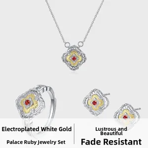 Detail of s925 silver necklace, ring and earrings set with red rubies and floral engravings