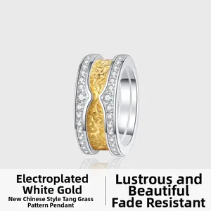 Detail of S925 silver pendant with gold arabesque texture and sparkling zircon borders