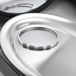 Detailed macro of S925 silver open bangle with colorful zircon-encrusted cylinders