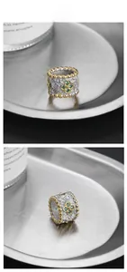 Detail view of S925 silver retro ring with 18K gold edges and green clover engraving