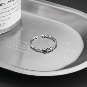 Minimalist S925 sterling silver twist ring with purple zircon gradient on steel tray