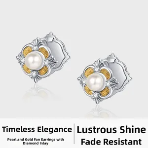 Macro shot of S925 silver pearl earrings with gold fan texture and diamond accents