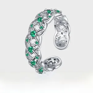Macro view of interwoven S925 silver band with inlaid emerald-green zircon stones