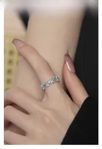 Close-up of S925 silver ring featuring emerald zircon inlays and hollow pattern