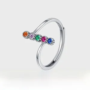 Macro detail of S925 sterling silver stamp and colorful gemstone row on open ring