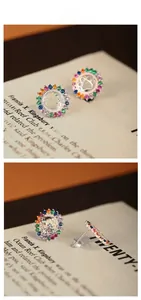 Close-up of S925 silver cat paw stud earrings with colorful zircon stones inlay