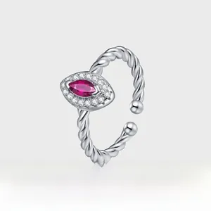 Macro shot of marquise-cut pigeon blood red ruby set in silver twisted open ring band