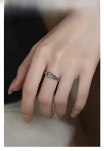 Detailed view of an oxidized S925 silver knot ring on a model finger for daily wear