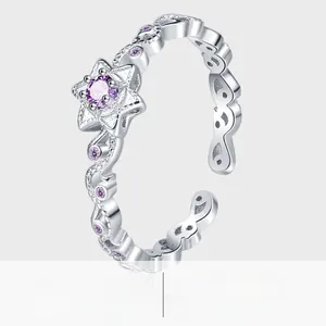 Detailed close-up of S925 silver star ring with purple crystal and hollow wavy band