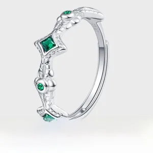 Macro detail of S925 sterling silver ring featuring emerald gemstone and vine engraving