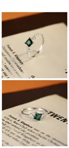 Detail view of square green emerald silver ring with micro-pave cubic zirconia side stones
