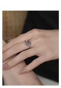 Detailed macro of vintage silver and gold ring with red stone and hollow metalwork