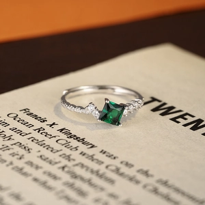 Luxurious S925 sterling silver square emerald ring with diamond accents on vintage paper