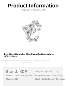 Macro view of S925 silver clover ring detailing orange zircons and white pearl inlay
