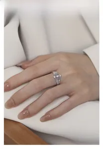 Macro detail of silver lace moonstone ring with pave diamonds on model's hand