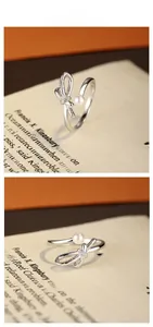 Close-up of S925 silver bow ring with pearl and diamonds on vintage book pages