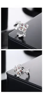 Detailed macro view of S925 silver open ring with red stones and pearl accents