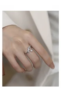 Close-up of S925 silver bow ring with pearl and diamonds worn for a daily commute