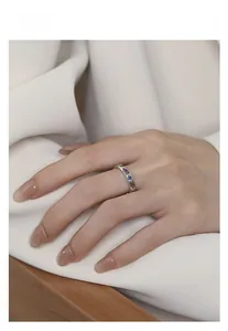 Close-up of S925 sterling silver ring with colorful zircon stones worn on finger