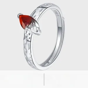Macro detail of S925 silver ring featuring marquise red zircon and hammered texture