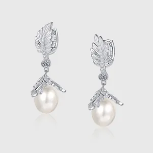 Detail of S925 silver pearl drop earrings with vine leaf design and platinum plating