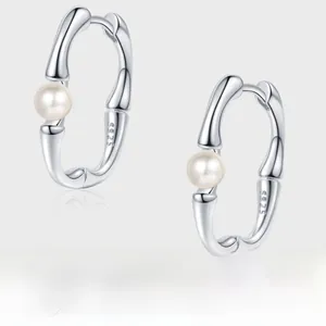 Detailed view of S925 sterling silver bamboo hoop earrings with white pearls
