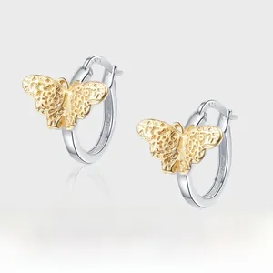 Macro detail of S925 sterling silver butterfly earrings with two-tone finish and texture