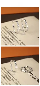 Detailed view of S925 sterling silver bamboo hoop earrings with white round pearls