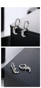 Close-up of S925 sterling silver crescent earrings with vintage meteorite texture and star