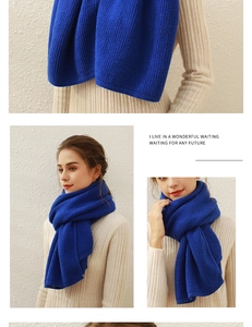 Detail of royal blue knitted scarf featuring thick texture and soft cashmere-like material