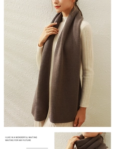 Detail of coffee brown vertical stripe knit scarf paired with a cream dress for winter