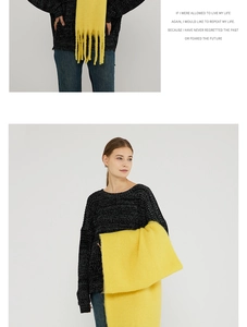 Detail of soft yellow mohair scarf with fringes paired with a textured knit sweater