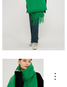 Detailed view of the soft mohair texture and thick fringe on this green winter scarf