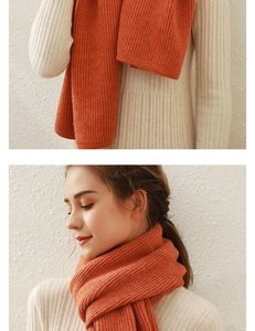 Close-up of ribbed knit texture and soft warm orange faux cashmere winter scarf