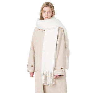 Thick white faux cashmere scarf with tassels paired with minimalist winter wool coat