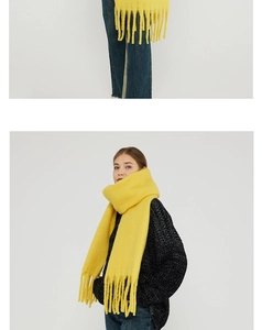 Detailed close-up showing thick mohair texture and long fringes on this yellow scarf
