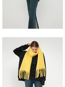 Close-up of thick bright yellow mohair knit scarf with long decorative tassels