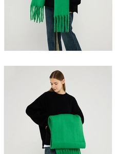 Close-up of bright green mohair scarf with soft knitted texture and tassel details