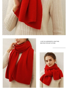 Detail of red knitted scarf with chunky vertical stripes and soft cashmere-like texture