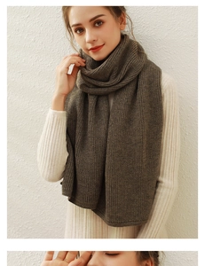 Detailed texture of dark brown chunky knit scarf showing thick premium yarn quality