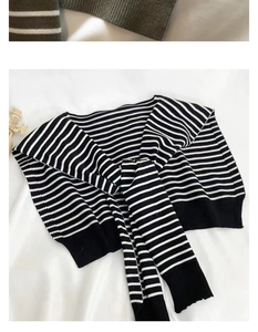 Detail of Korean style striped knit shawl featuring black and white patterns with soft texture