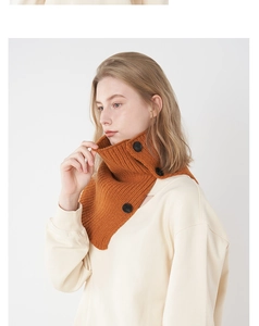 Detail of caramel knitted wool collar scarf with three large black decorative buttons