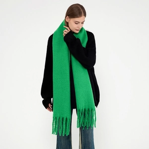 Bright green thick knit mohair scarf with chunky tassels for winter warmth