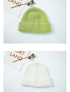 Detailed close-up of ribbed knit wool beanies in neon green and off-white colors